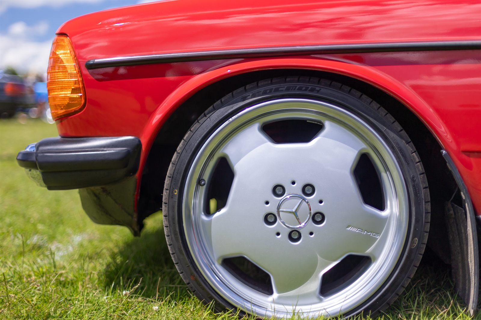 Polished AMG monoblock alloy wheel on the red Mercedes W123